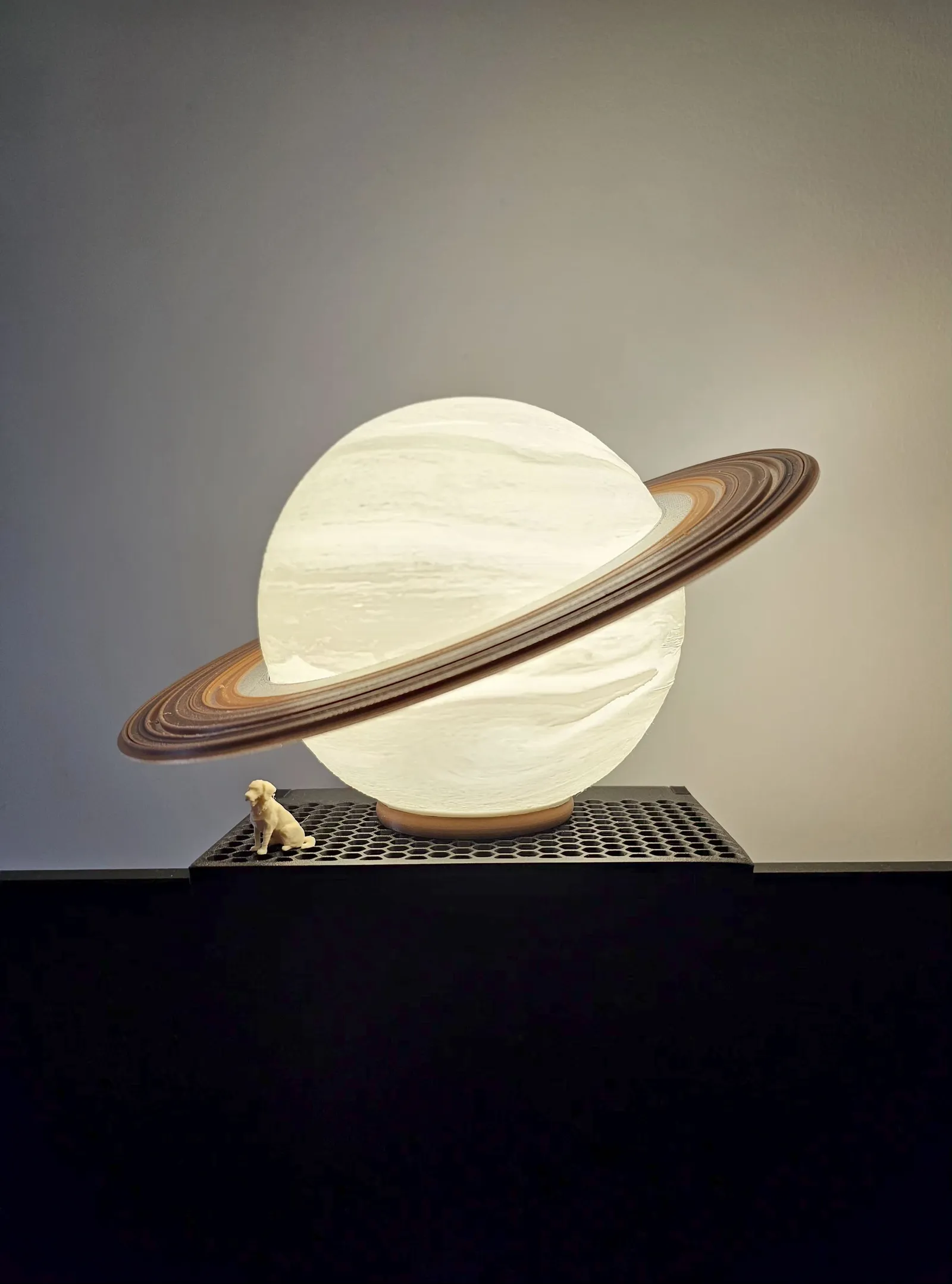 A dome table lamp glowing warmly on an oak surface