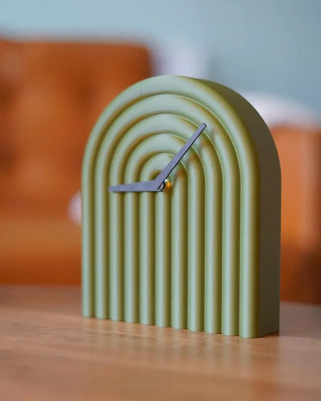 Solace Clock, a sage green arched clock with concentric ridges
